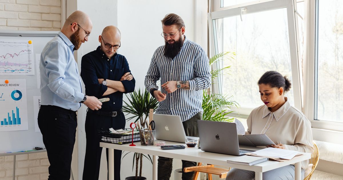 A small team working together at their laptops in an office